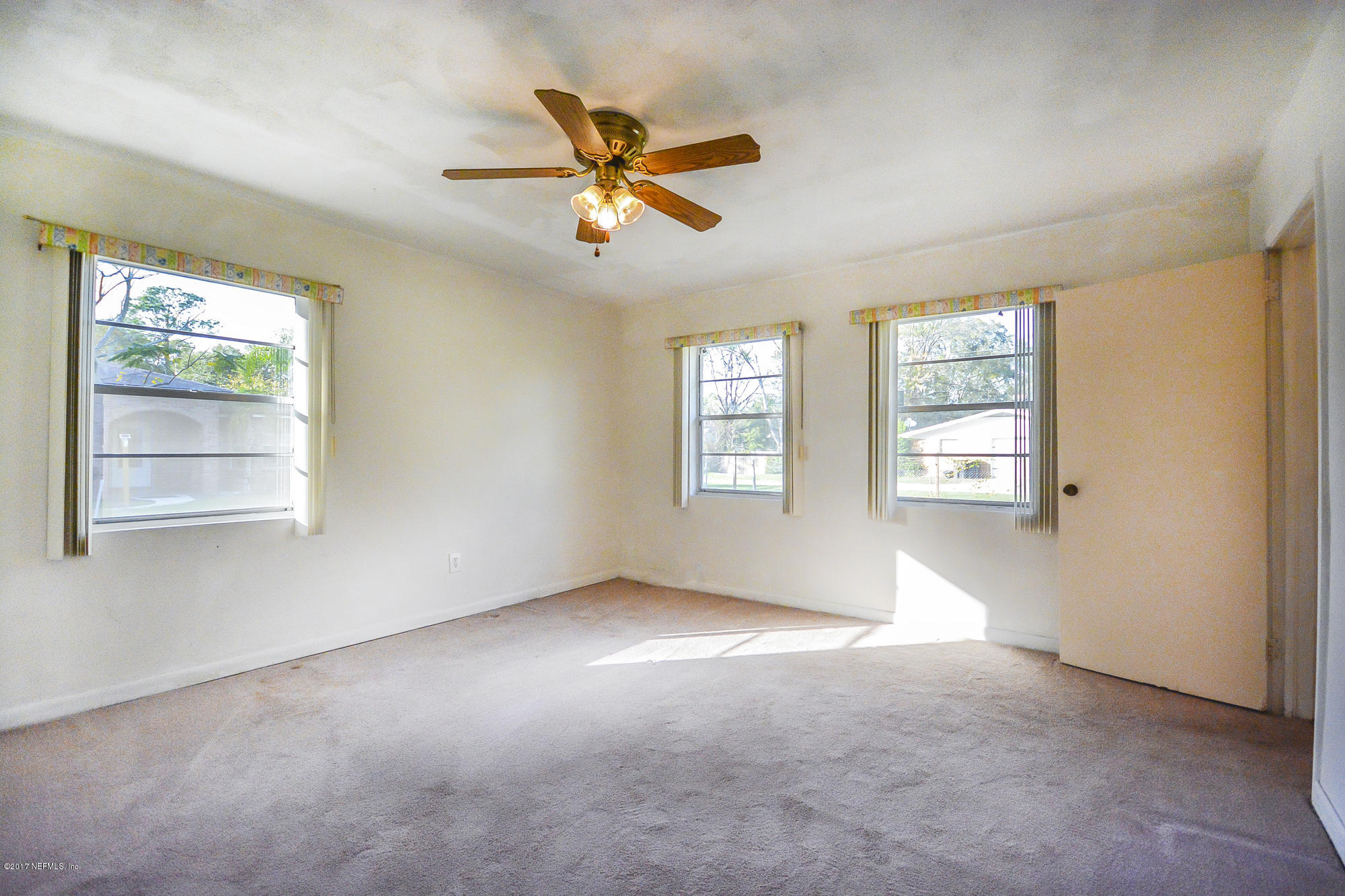 4822 Ricker Road Jacksonville, FL 32210 - Photo 45 of 50 a view of a livingroom with a ceiling fan and window