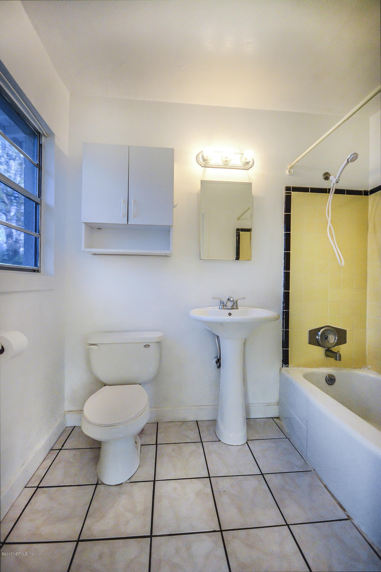 4822 Ricker Road Jacksonville, FL 32210 - Photo 47 of 50 a bathroom with a sink a toilet and mirror