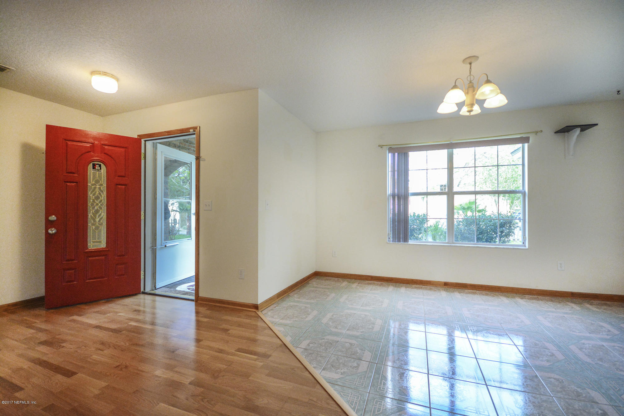 4822 Ricker Road Jacksonville, FL 32210 - Photo 8 of 50 wooden floor in an empty room with a window
