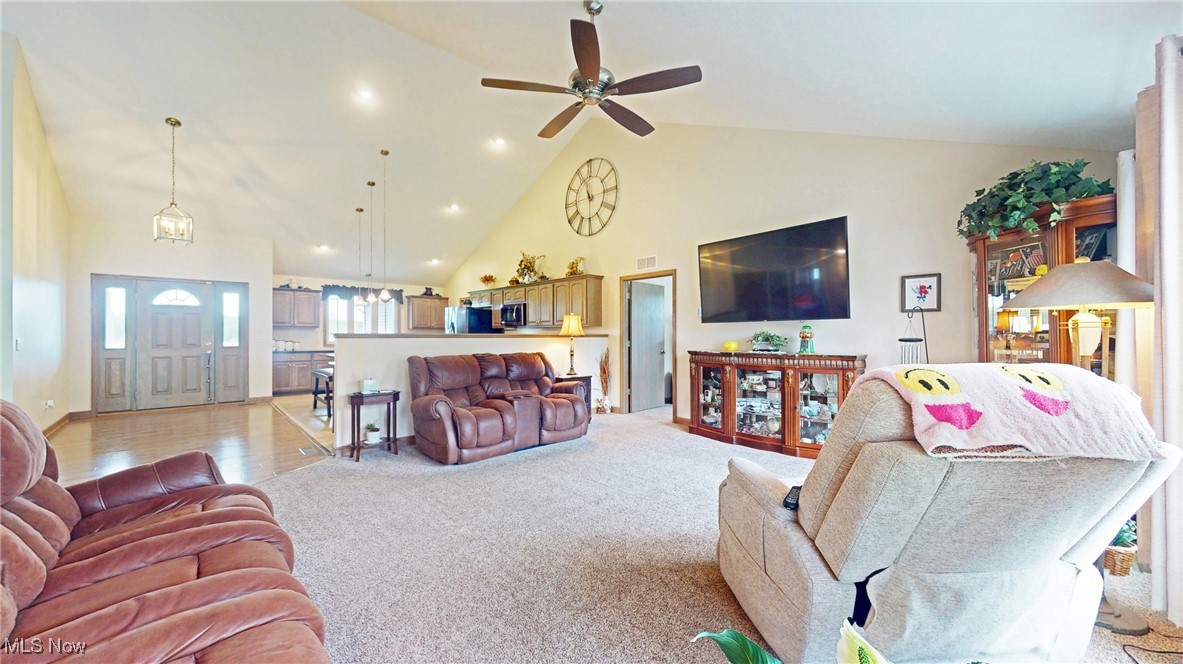 961 Industry Road Atwater, OH 44201 - Photo 11 of 50 Living room featuring high vaulted ceiling, light colored carpet, ceiling fan, and recessed lighting
