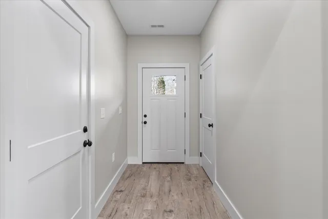 a view of a hallway with wooden floor