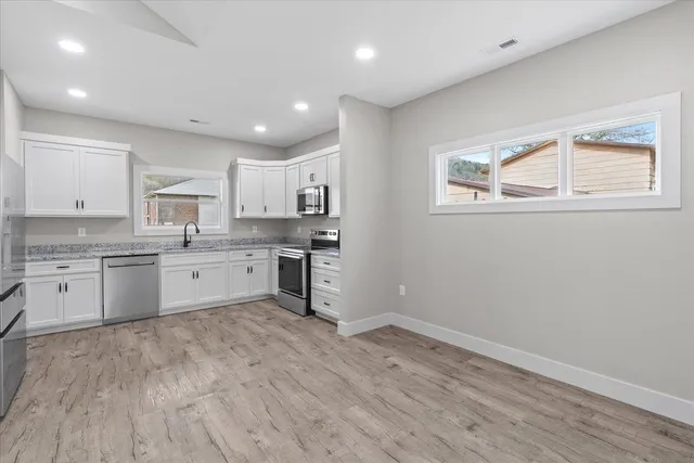 a kitchen with wooden floors and white appliances