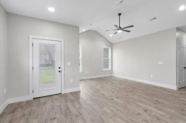 wooden floor in an empty room with a window