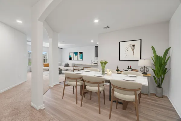 a view of a dining room with furniture and wooden floor