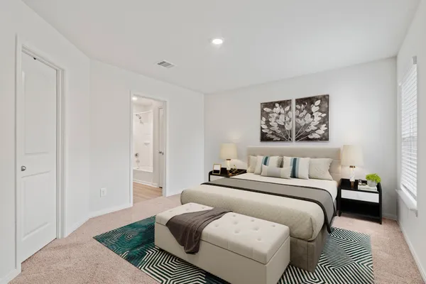 a bedroom with a bed and a couch