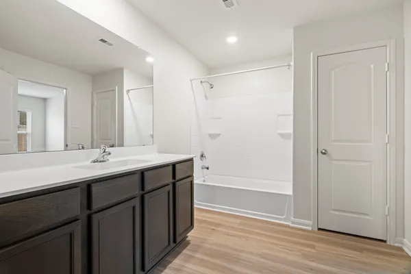 a bathroom with a double vanity sink and mirror