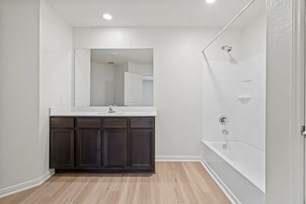 a bathroom with a sink a mirror and a bathtub