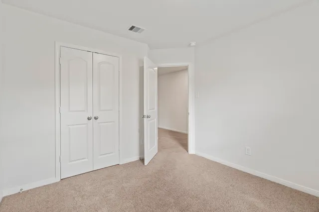 a view of an empty room and closet area