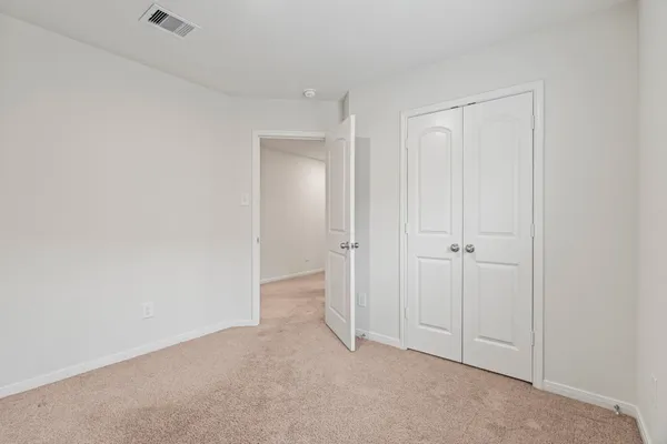 a view of an empty room and closet area