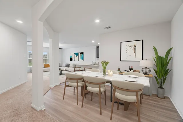 a living room with furniture ceiling fan and a window