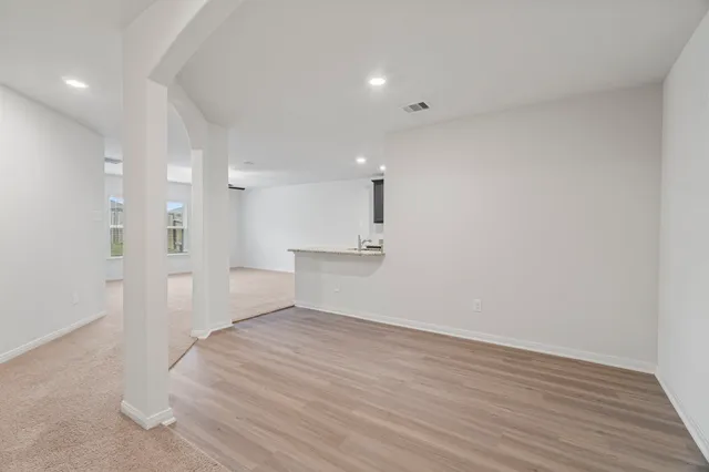 a living room with furniture ceiling fan and a window