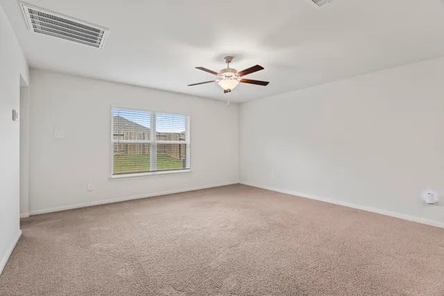 a view of kitchen and empty room with wooden floor