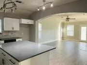 a view of a kitchen with a sink and cabinets