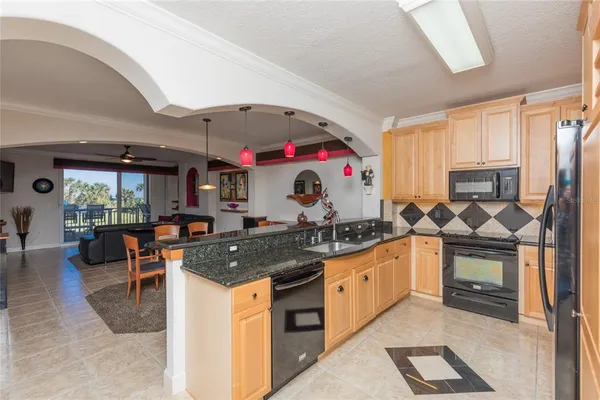 a view of a kitchen with dining table and chairs