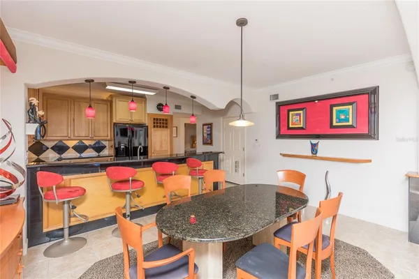 a living room with furniture and a view of kitchen
