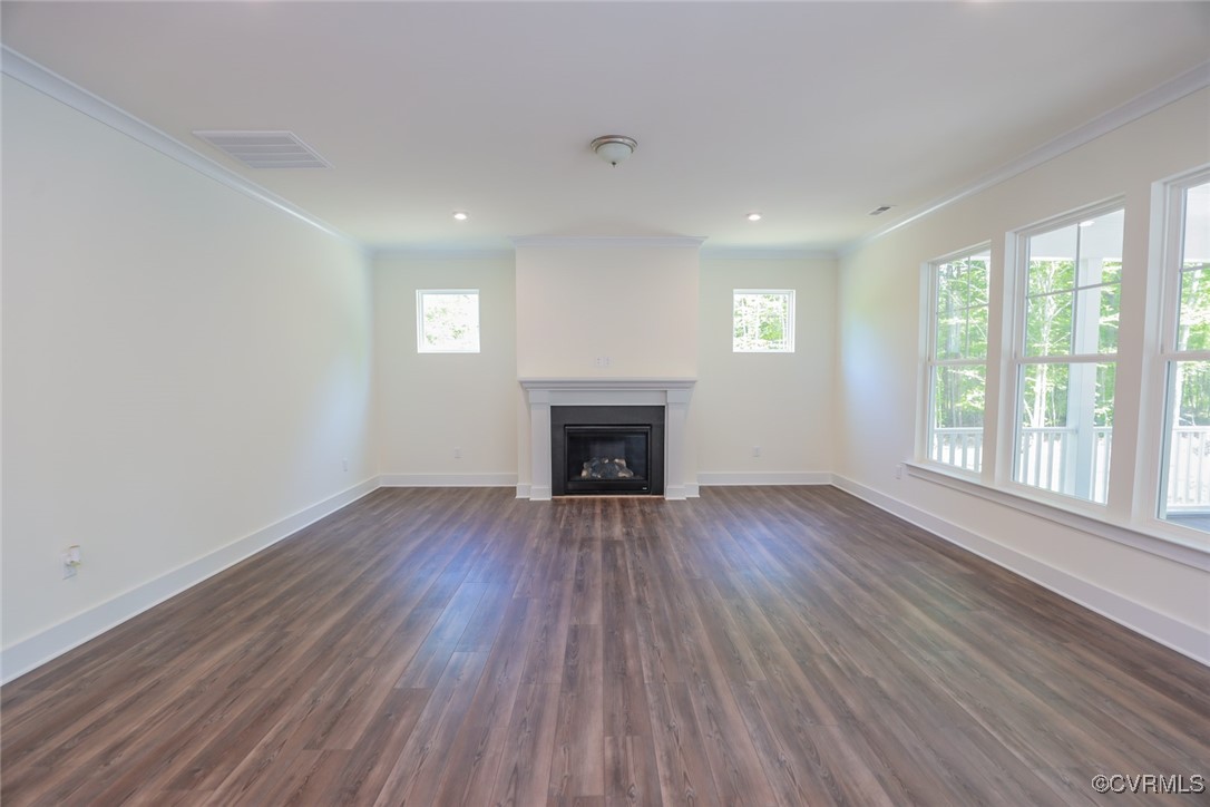 16877 Watchman Way Beaverdam, VA 23015 - Photo 3 of 15 a view of an empty room with wooden floor and a window
