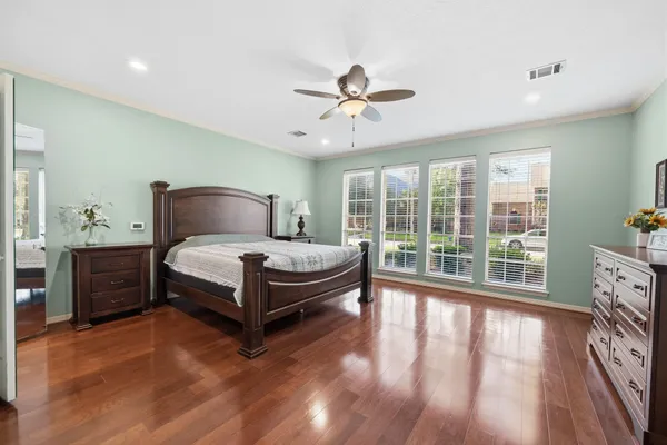 a bedroom with a bed and wooden floor