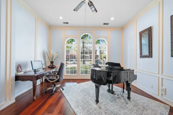 a living room with furniture rug and wooden floor