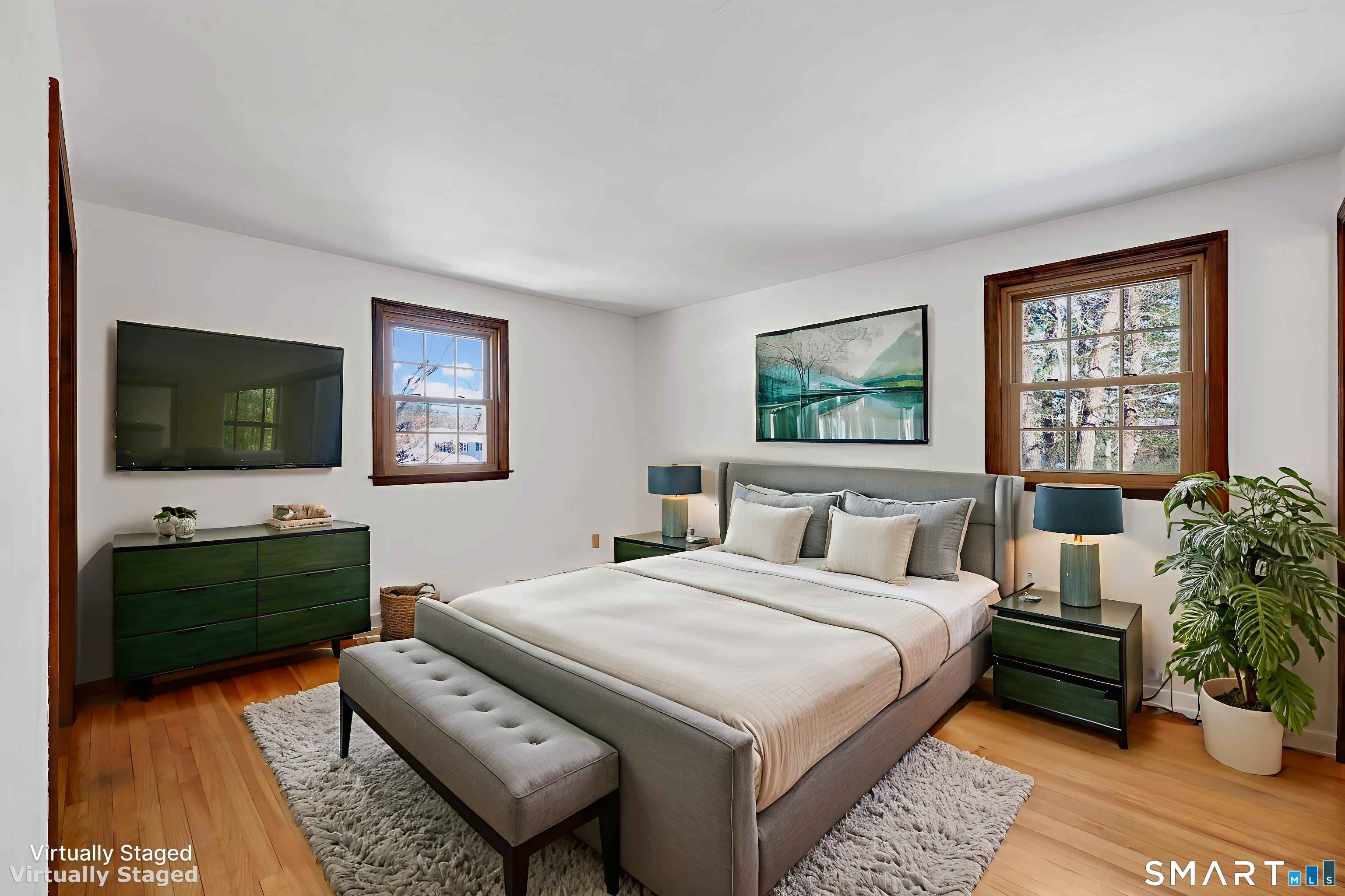 102 Robin Circle Tolland, CT 06084 - Photo 15 of 37 a bedroom with a bed a couch and a flat screen tv