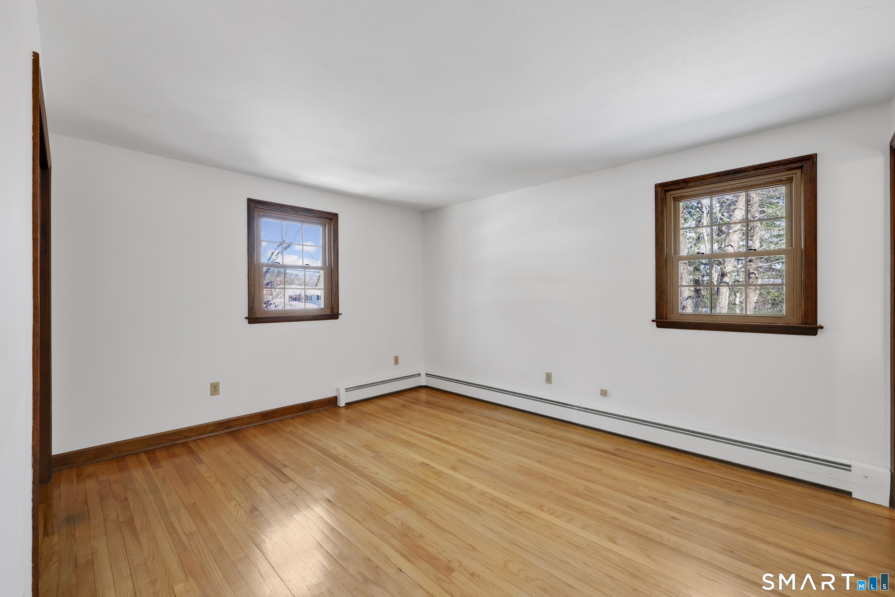 102 Robin Circle Tolland, CT 06084 - Photo 16 of 37 a view of empty room with wooden floor and fan