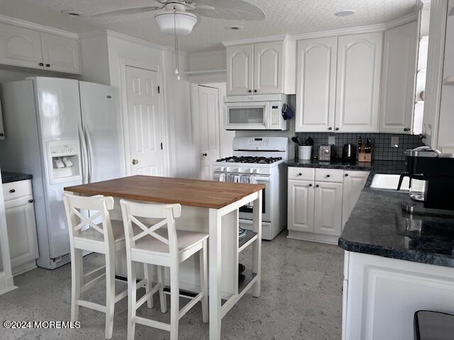 113 Webb Avenue, Unit WINTER Ocean Grove, NJ 07756 - Photo 17 of 31 a kitchen with stainless steel appliances kitchen island granite countertop a table chairs sink and cabinets