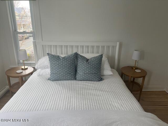 113 Webb Avenue, Unit WINTER Ocean Grove, NJ 07756 - Photo 27 of 31 a bedroom with a bed and wooden floor