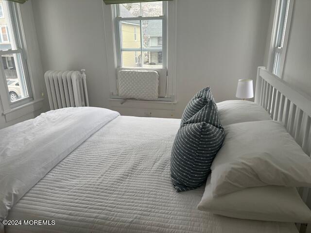 113 Webb Avenue, Unit WINTER Ocean Grove, NJ 07756 - Photo 28 of 31 a bedroom with a bed and a window