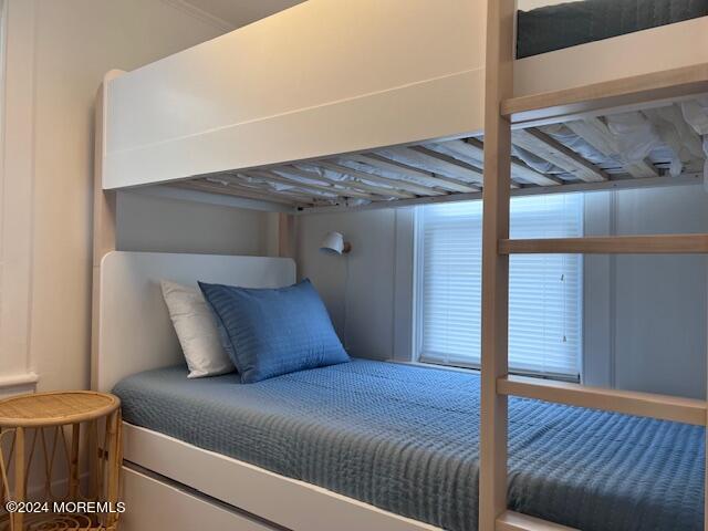 113 Webb Avenue, Unit WINTER Ocean Grove, NJ 07756 - Photo 29 of 31 a bedroom with a bed and wooden floor