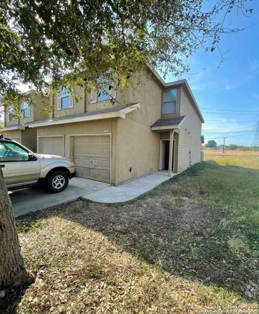 7301 Longing Trail, Unit 1 San Antonio, TX 78244 - Photo 2 of 16 a front view of a house with a yard