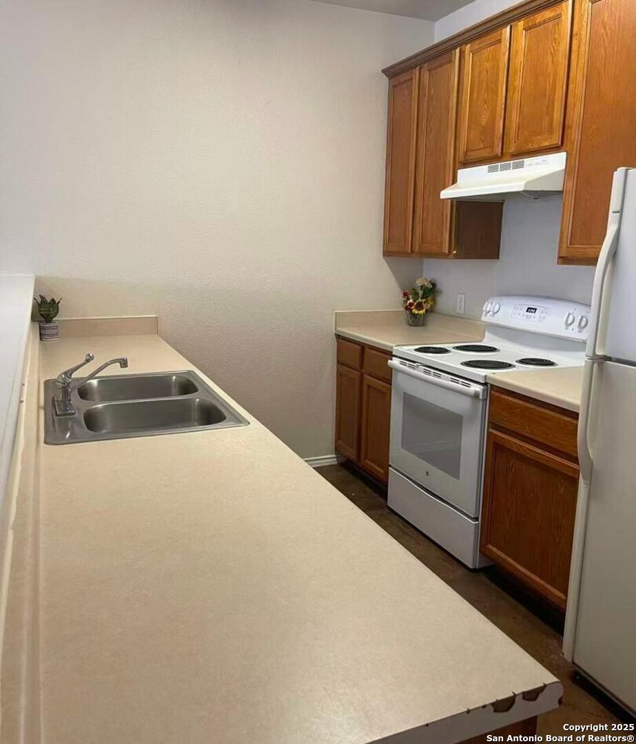 7301 Longing Trail, Unit 1 San Antonio, TX 78244 - Photo 7 of 16 a kitchen with a stove and a sink