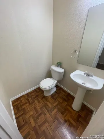 a bathroom with a toilet and a mirror