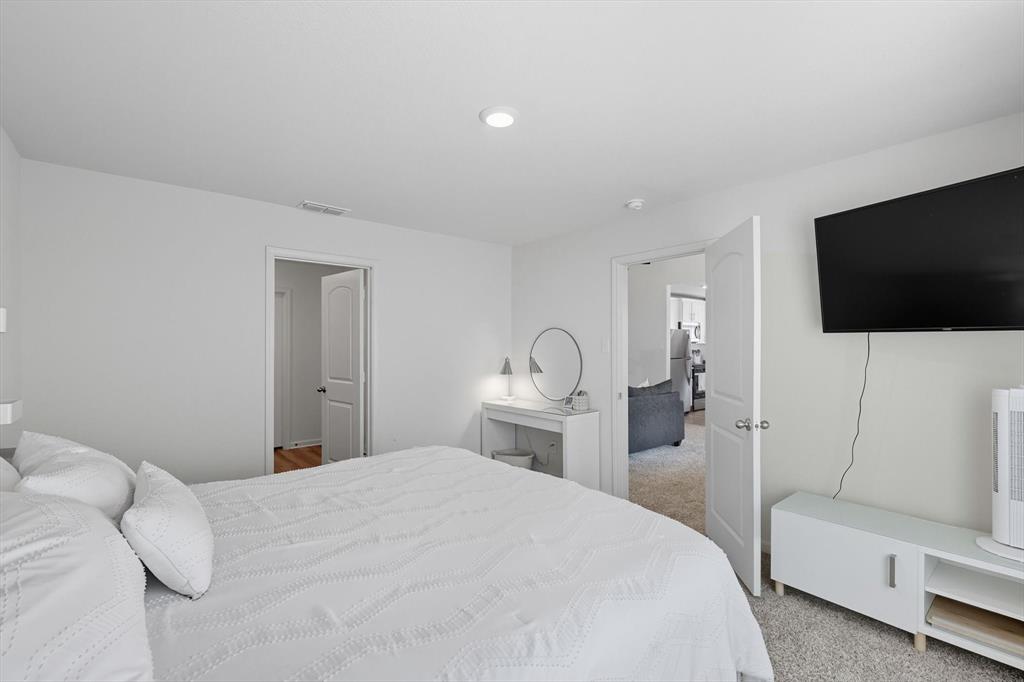 13511 Mineral Road Ponder, TX 76259 - Photo 24 of 40 a bedroom with a bed and a flat screen tv