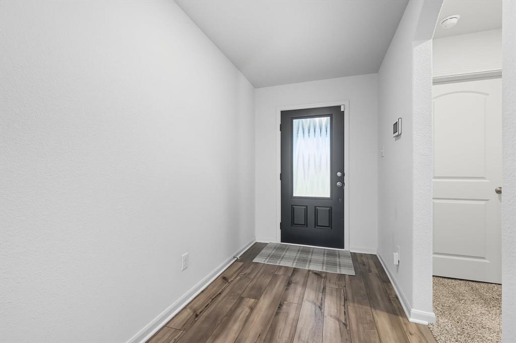 13511 Mineral Road Ponder, TX 76259 - Photo 6 of 40 a view of a room with wooden floor and a window