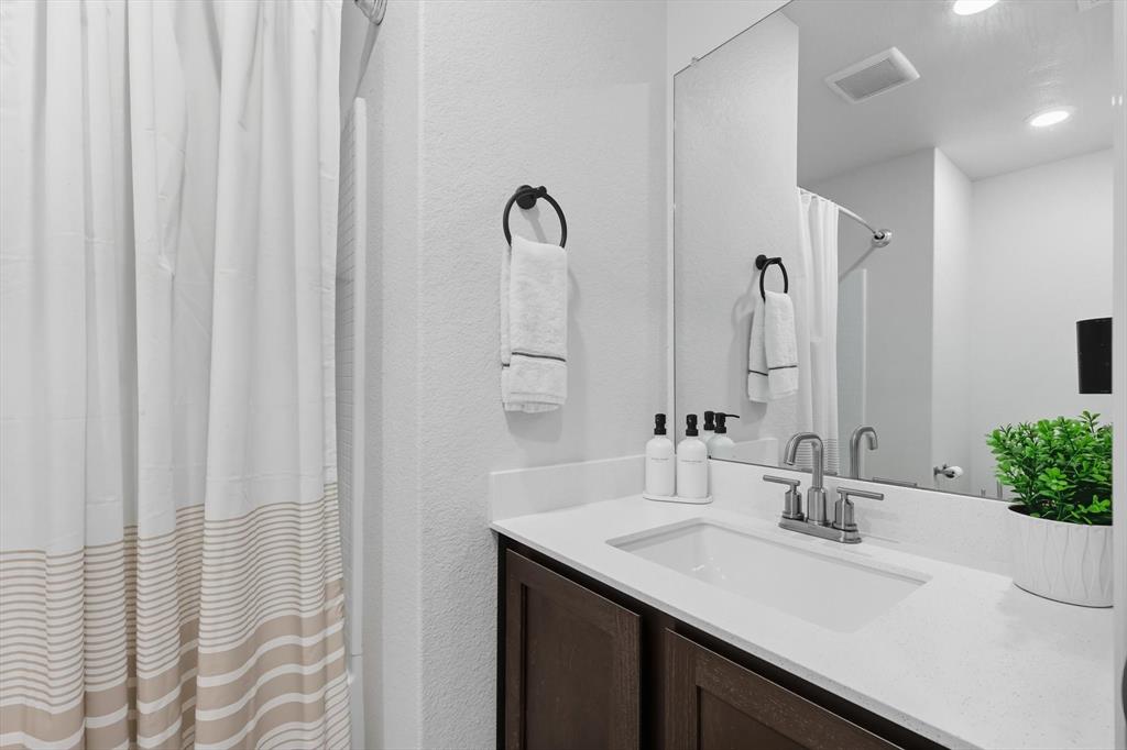 13511 Mineral Road Ponder, TX 76259 - Photo 9 of 40 a bathroom with a double vanity sink and a mirror