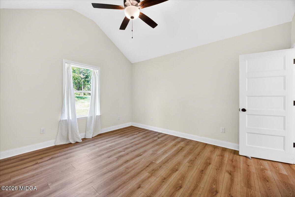 845 Natures Walk Gray, GA 31032 - Photo 13 of 21 an empty room with wooden floor fan and windows