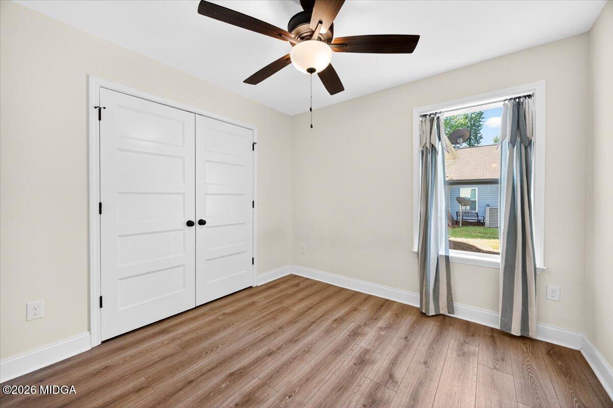 845 Natures Walk Gray, GA 31032 - Photo 14 of 21 an empty room with wooden floor a ceiling fan and closet