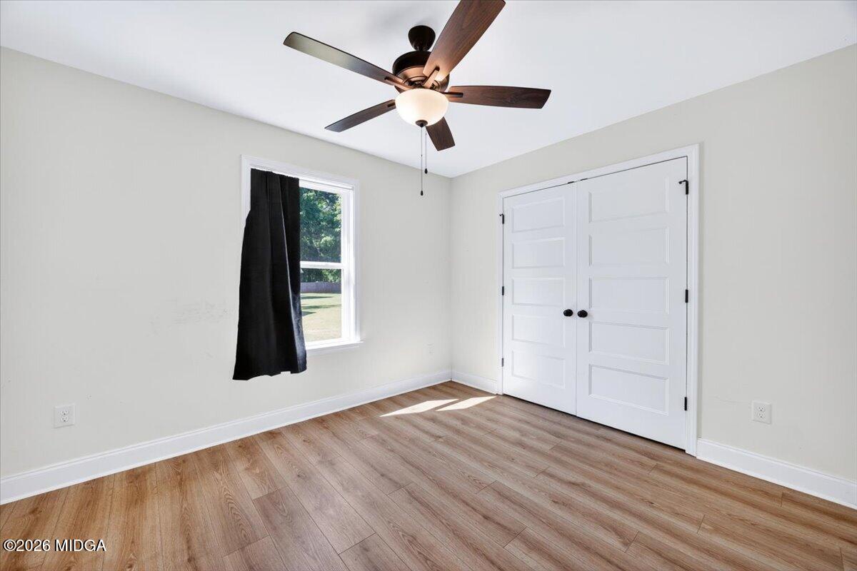 845 Natures Walk Gray, GA 31032 - Photo 16 of 21 a view of an empty room with wooden floor and a ceiling fan