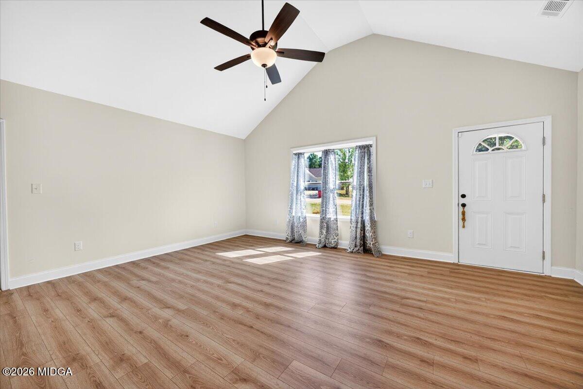 845 Natures Walk Gray, GA 31032 - Photo 4 of 21 an empty room with wooden floor and windows