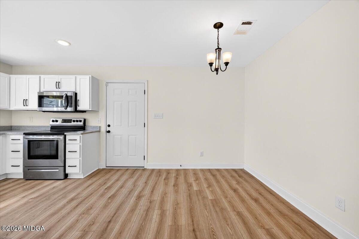 845 Natures Walk Gray, GA 31032 - Photo 6 of 21 a view of a kitchen with wooden floor and electronic appliances