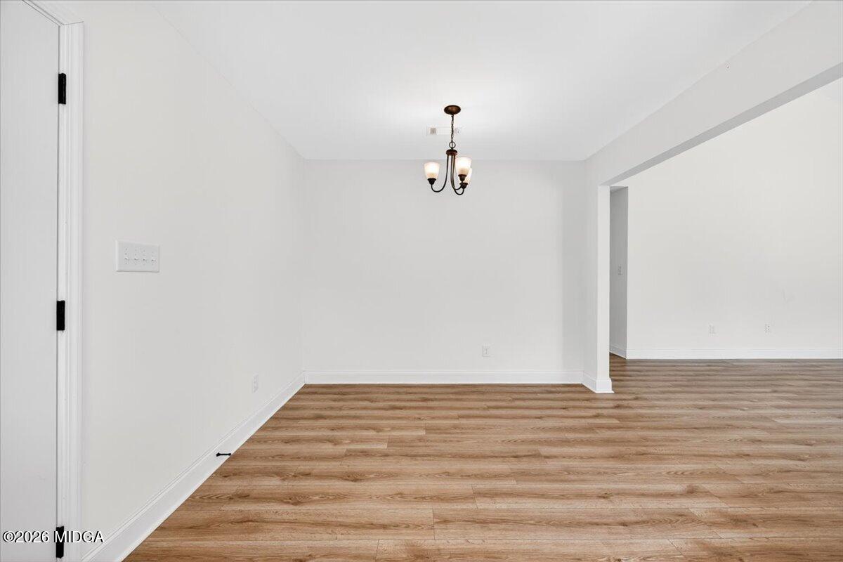 845 Natures Walk Gray, GA 31032 - Photo 10 of 21 a view of a room with wooden floor and white walls
