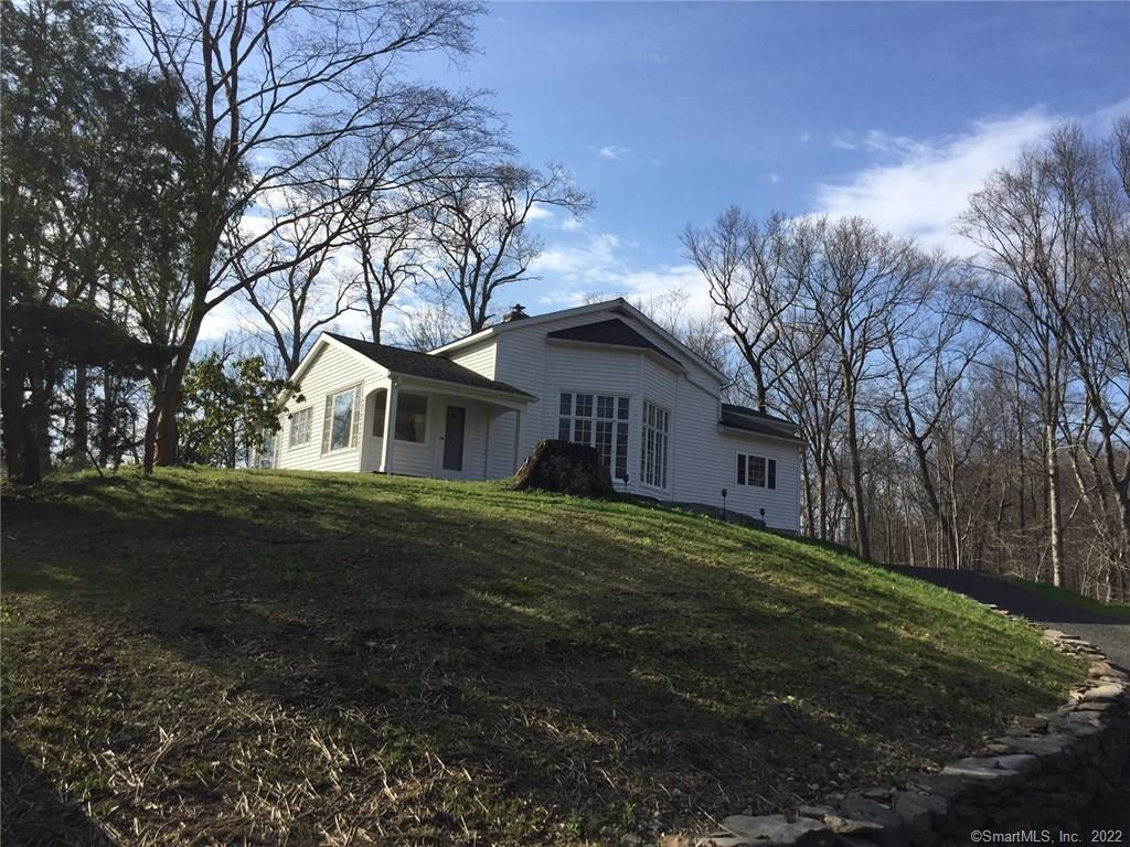 204 Bacon Road Roxbury, CT 06783 - Photo 1 of 1 a front view of a house with a garden