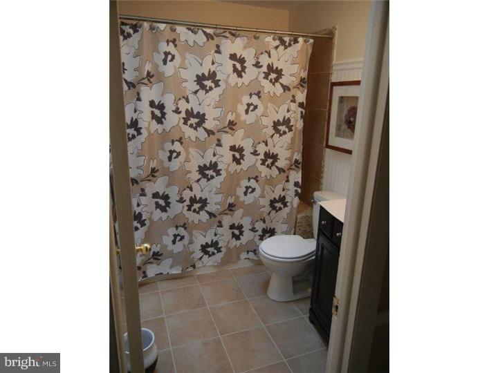 739 Spruce Road Warminster, PA 18974 - Photo 16 of 19 a bathroom with a toilet and a shower curtain