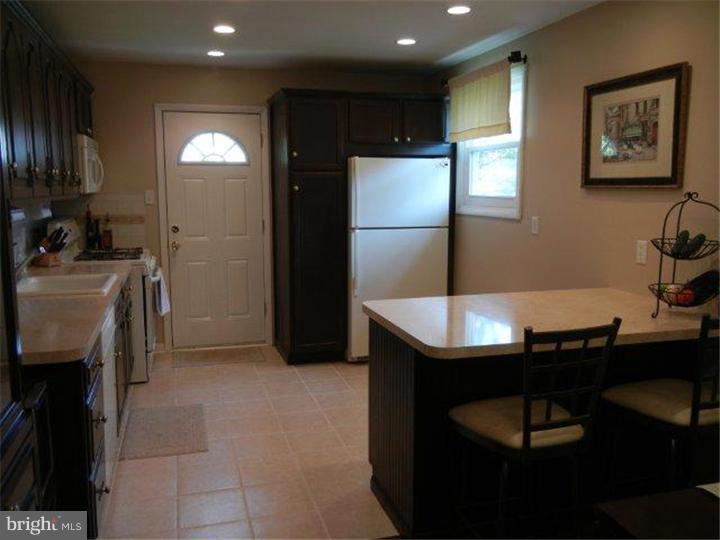 739 Spruce Road Warminster, PA 18974 - Photo 4 of 19 a kitchen with kitchen island a sink stainless steel appliances and cabinets