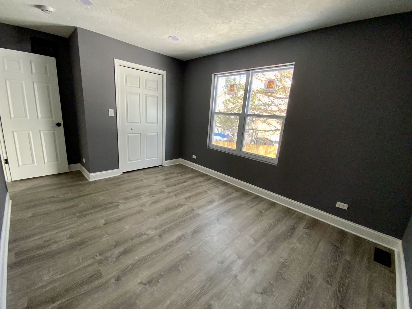 4014 Ridge Road Zion, IL 60099 - Photo 14 of 21 an empty room with wooden floor and windows