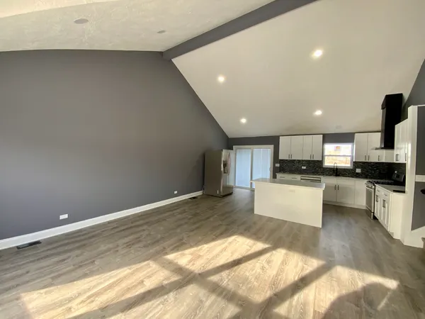 a view of kitchen with refrigerator sink and stove