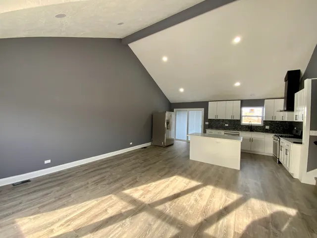 a view of kitchen with refrigerator sink and stove