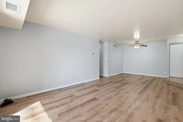 a view of empty room with ceiling fan