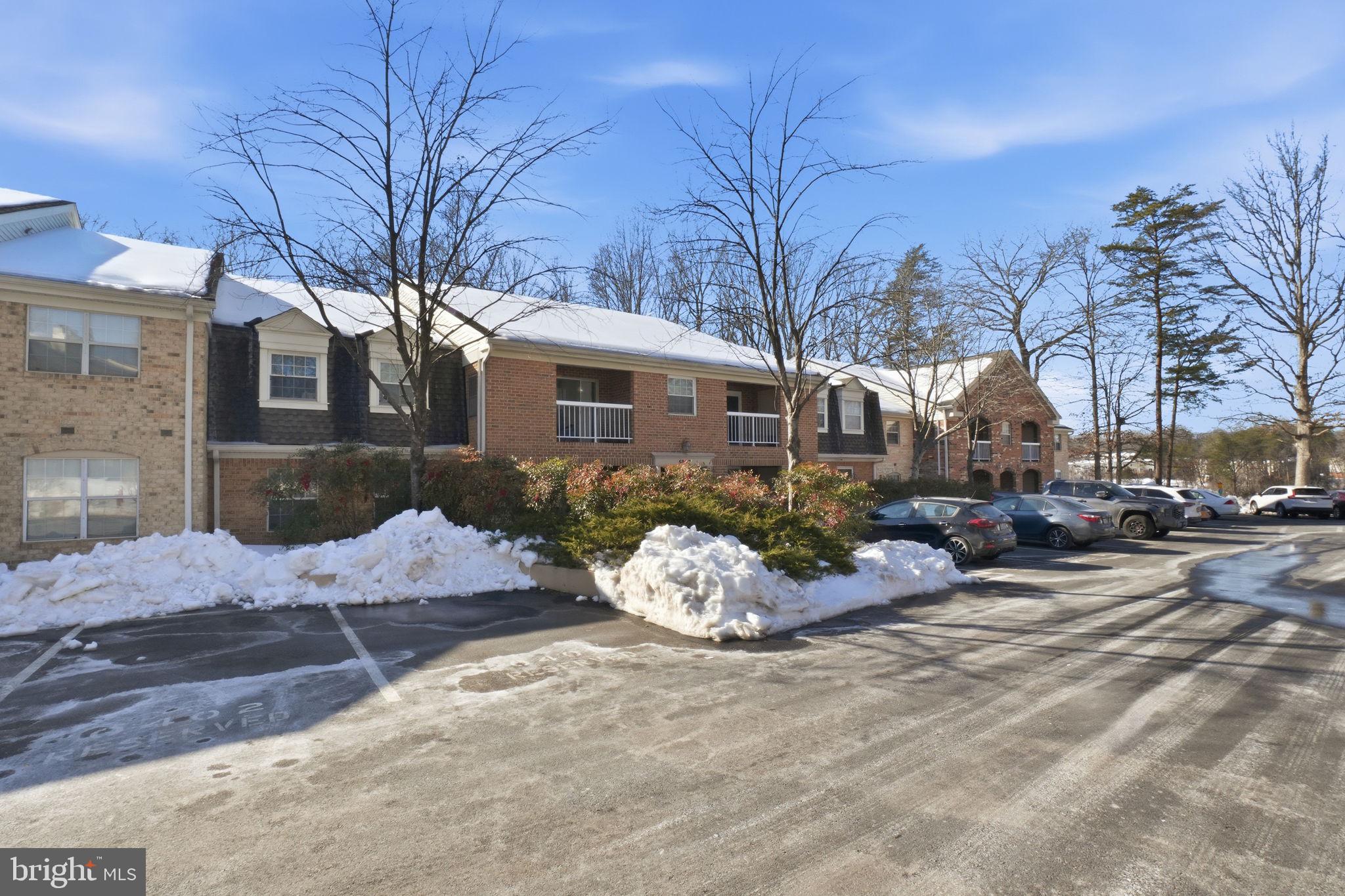 5902 Cove Landing Road, Unit 203 Burke, VA 22015 - Photo 2 of 25 a view of a house with a yard covered in snow