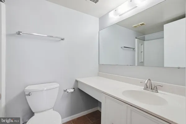 a bathroom with a sink a toilet and a mirror