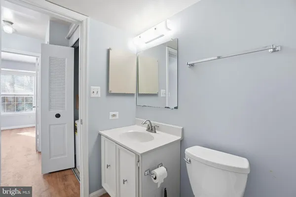 a bathroom with a toilet sink and mirror